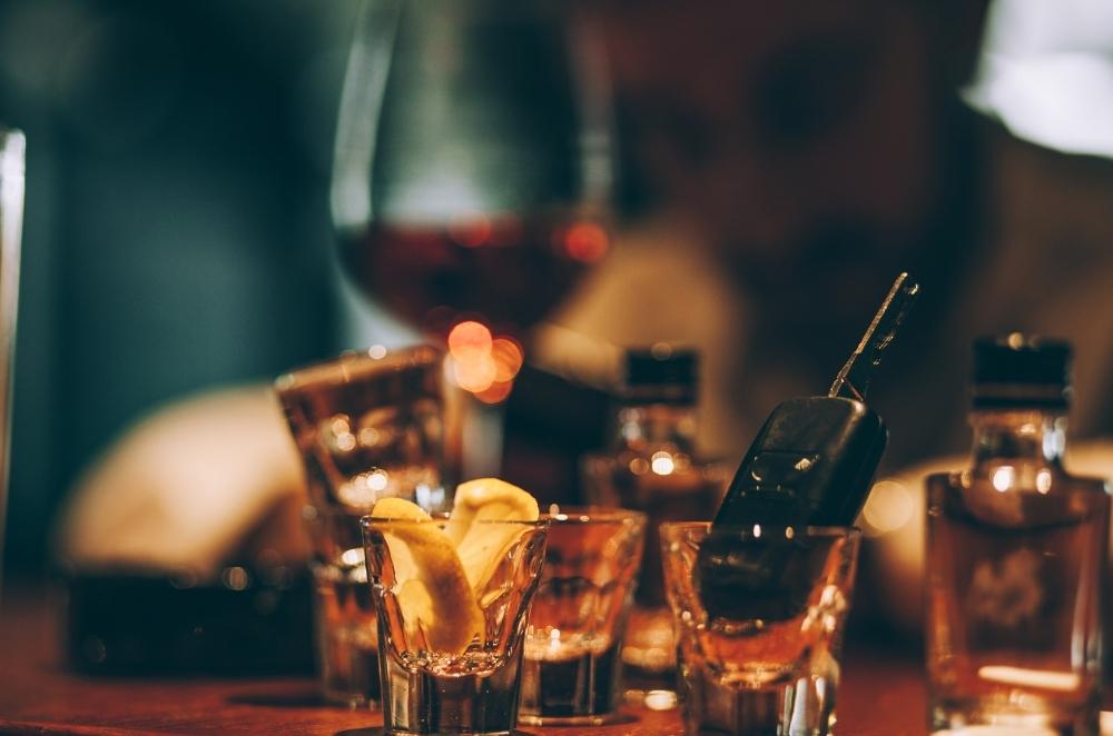 a bunch of shot glasses with a car key in one